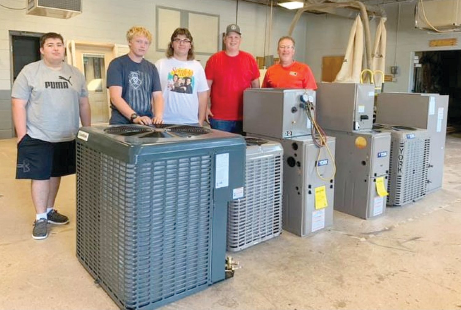 Mr. Stigall and students with HVAC units donated by CFM Distributors, a supplier for Shannon Heating and Cooling.
